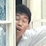 man opening window in alley