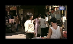 screenshot from THE SYSTEM; <br>
in the background Chang Cheh's THE DAREDEVILS (1979) is announced in the streets of Hong Kong